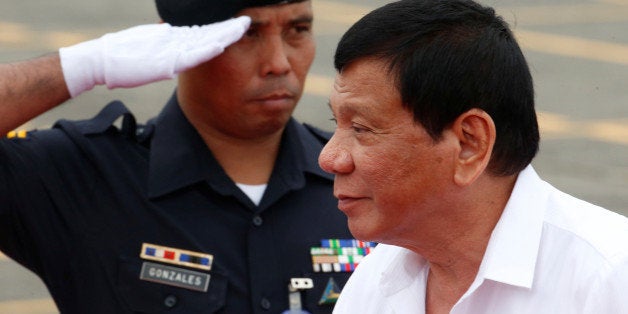 REFILE - FIXING TYPO A soldier salutes as Philippine President Rodrigo Duterte arrives to take part during the change of comm