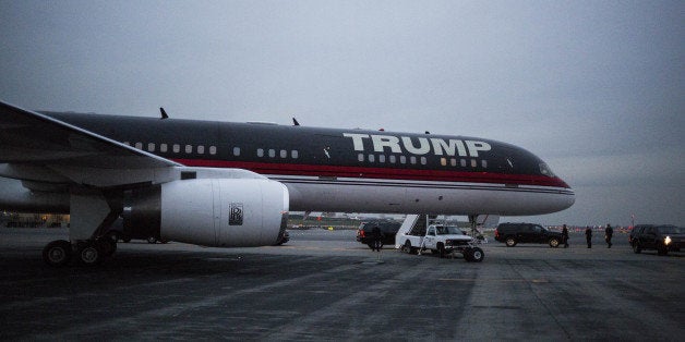 The plane of U.S. President-elect Donald J. Trump stands at LaGuardia Airport (LGA) in the Queens borough of New York, U.S., on Tuesday, Dec. 13, 2016. Exxon Mobil Corp. Chief Executive Officer Rex Tillerson will be nominated as Trump's secretary of state, setting up a potential confirmation battle with U.S. lawmakers who have questioned the oilman's relationship with Russian President Vladimir Putin. Photographer: John Taggart/Bloomberg via Getty Images