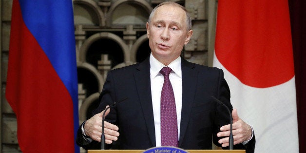 Russian President Vladimir Putin gestures as he speaks during a joint news conference with Japanese Prime Minister Shinzo Abe
