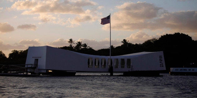 The USS Arizona Memorial is pictured at sunset in Pearl Harbor, Hawaii, December 29, 2011. U.S. President Barack Obama and first lady Michelle Obama took part in a wreath-laying ceremony and tossed flower petals into the harbor during their visit on Thursday. REUTERS/Jason Reed (UNITED STATES - Tags: POLITICS)