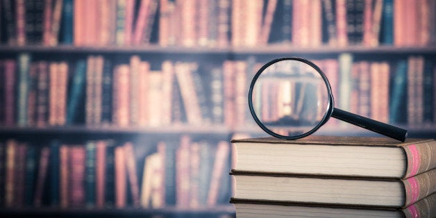 Books and magnifying glass