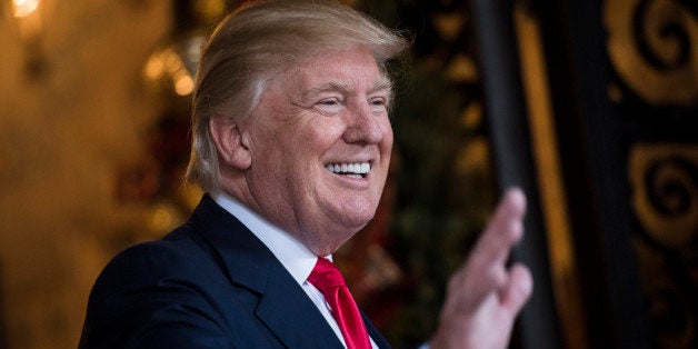 PALM BEACH, FL - DECEMBER 21: President-Elect Donald J. Trump waves to members of the media after a meeting with military lea