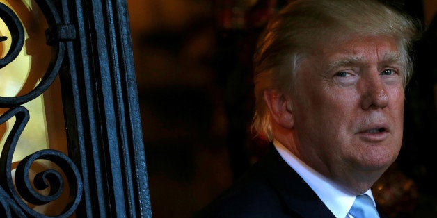 U.S. President-elect Donald Trump speaks briefly to reporters between meetings at the Mar-a-lago Club in Palm Beach, Florida,