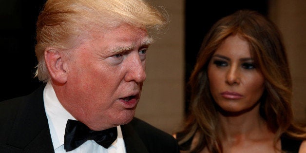 U.S. President-elect Donald Trump talks to reporters as he and his wife Melania Trump arrive for a New Year's Eve celebration