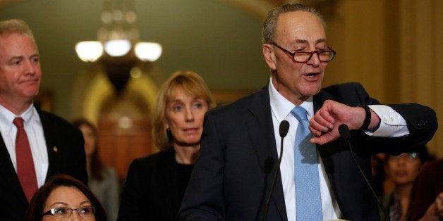 U.S. Senate Minority Leader Chuck Schumer (D-NY), flanked by freshman Democrats Senator Chris Van Hollen (D-MD) (L), Senator