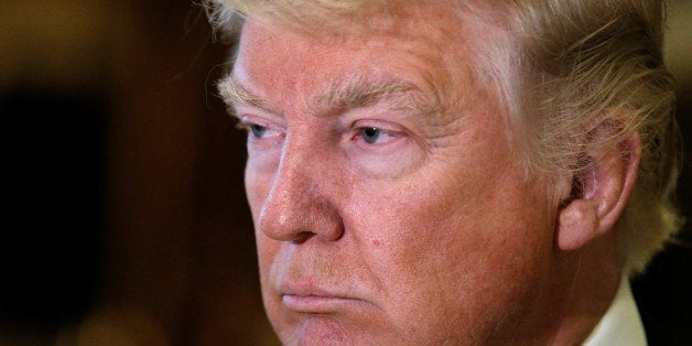 U.S. President-elect Donald Trump listens to questions from reporters in the lobby at Trump Tower in New York, U.S., January