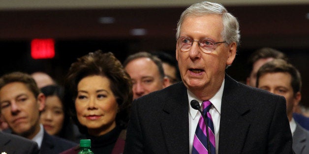 U.S. Senate Majority Leader Mitch McConnell (R-KY) introduces his wife Elaine Chao (L) to testifies before a Senate Commerce Science and Transportation Committee confirmation hearing on her nomination to be transportation secretary on Capitol Hill in Washington, U.S., January 11, 2017. REUTERS/Carlos Barria