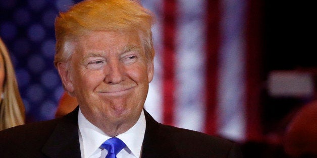 Republican U.S. presidential candidate Donald Trump smiles as he speaks at the start of a campaign victory party after rival