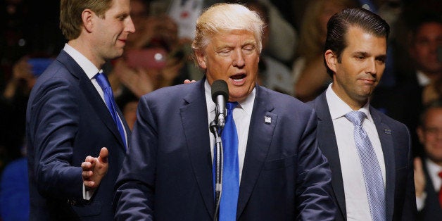 Republican U.S. presidential nominee Donald Trump gets smiles from his sons Eric Trump (L) and Donald Trump Jr. (R) as they leave him to take the stage to rally with supporters at an arena in Manchester, New Hampshire, U.S. November 7, 2016. REUTERS/Jonathan Ernst