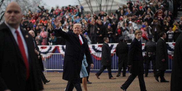 U.S. President Donald Trump walks with wife Melania and son Barron during the Inaugural Parade in Washington, January 20, 201