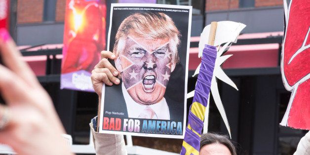 San Diego, California, USA - May 27, 2016: A protester holds a sign featuring an angry photo of Donald Trump and reading 'Bad for America' at an anti-Trump protest outside a Trump rally in San Diego.