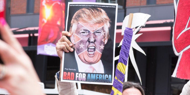 San Diego, California, USA - May 27, 2016: A protester holds a sign featuring an angry photo of Donald Trump and reading 'Bad