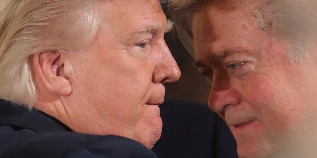 U.S. President Donald Trump talks to senior staff Steve Bannon during a swearing in ceremony for senior staff at the White House in Washington, DC January 22, 2017. REUTERS/Carlos Barria