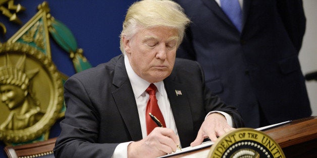 US President Donald Trump signs Executive Orders in the Hall of Heroes at the Department of Defense in Virginia, January 27,