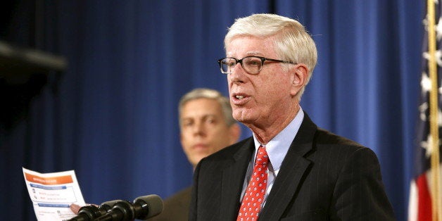 Iowa Attorney General Tom Miller answers questions at a news conference at the Justice Department in Washington, November 16,