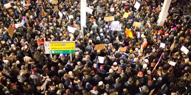 NEW YORK, NY - JANUARY 28: After U.S. President Trump issued a travel ban on seven Muslim nations, and travelers with visas to the United States were detained at JFK airport, protestors gather to demand that they be set free at Terminal 4 at JFK airport on January 28, 2017 in the Queens borough of New York City. International travelers tried to make their way through the demonstrators and the police. (Photo by Andrew Lichtenstein/Corbis via Getty Images)