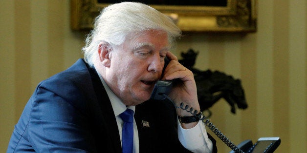 U.S. President Donald Trump speaks by phone with Russia's President Vladimir Putin in the Oval Office at the White House in Washington, U.S. January 28, 2017. REUTERS/Jonathan Ernst