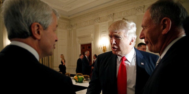 U.S. President Donald Trump shakes hands with JPMorgan Chase & Co CEO Jamie Dimon (L) as he hosts a strategy and policy forum