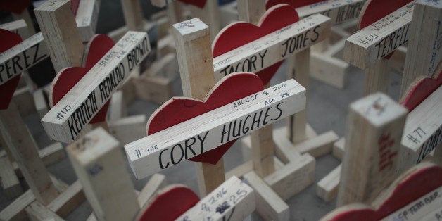 CHICAGO, IL - DECEMBER 31: Nearly 800 crosses, each bearing the name of a murder victim, sit on the sidewalk along Michigan Avenue before the start of a march on December 31, 2016 in Chicago, Illinois. Residents, activists and family members of victims of gun violence marched down Michigan Avenue carrying the crosses to draw attention to the city's rising murder rate. Nearly 800 people have been murdered in the city this year and more than 4000 shot as the city copes with its most violent year in two decades. (Photo by Scott Olson/Getty Images)