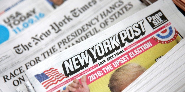The cover of the New York Post newspaper is seen with other papers at a newsstand in New York U.S., November 9, 2016. REUTERS
