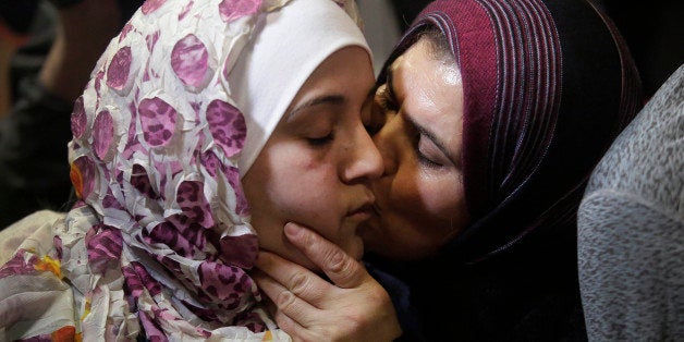 Syrian refugee Baraa Haj Khalaf,(L), receives a kiss from her mother Fattoum Haj Khalaf as she arrives at O'Hare International Airport on February 7, 2017 in Chicago, Illinois. Baraa Haj Khalaf and her family were previously banned from entering the United States after President Donald Trump signed an executive order banning immigrants from entering the country. The Justice Department faced tough questioning as it urged a court of appeals to reinstate President Donald Trump's travel ban targeting citizens of seven Muslim-majority countries -- put on hold by the courts last week. / AFP / Joshua LOTT (Photo credit should read JOSHUA LOTT/AFP/Getty Images)