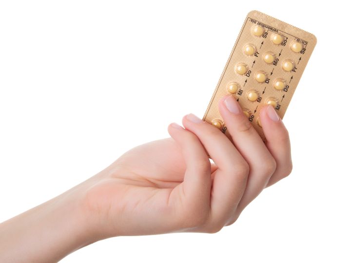 tablets (Birth Control Pills) in the hand, isolated on white background