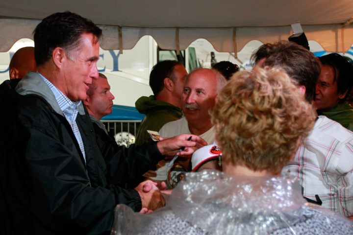 RICHMOND, VA - SEPTEMBER 08: Republican presidential candidate, former Massachusetts Gov. Mitt Romney signs autographs during a rain delay before the start of the NASCAR Sprint Cup Series Federated Auto Parts 400 at Richmond International Raceway on September 8, 2012 in Richmond, Virginia. (Photo by Geoff Burke/Getty Images)