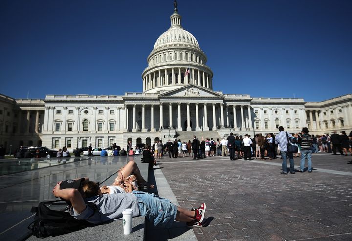 WASHINGTON, DC - SEPTEMBER 11: A couple relaxes before the start of a remembrance ceremony for the victims of the attacks of September 11 at a ceremony at the U.S. Capitol September 11, 2012 in Washington, DC. The nation's capital joined the rest of the nation in commemorating the eleventh anniversary of the September 11, 2001 attacks which resulted in the deaths of nearly 3,000 people after two hijacked planes crashed into the World Trade Center, one into the Pentagon in Arlington, Virginia and one crash landed in Shanksville, Pennsylvania. (Photo by Win McNamee/Getty Images)