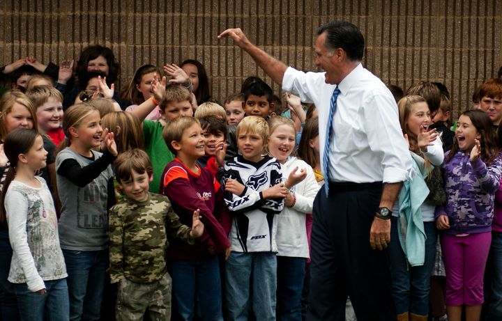 US Republican presidential candidate Mitt Romney waves to elementary students at Fairfeild Elementary in Fairfeild, VA, October 8, 2012 during an unscheduled stop. AFP PHOTO/Jim WATSON (Photo credit should read JIM WATSON/AFP/GettyImages)