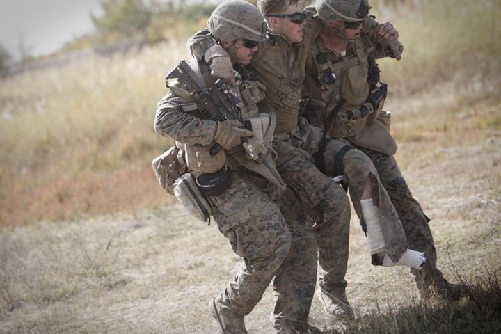 Us Marine lance corporal Zachary Densmor from 3rd Battalion, 7th Marines suffering from fractures in his leg is carried by his comrades to a medevac helicopter of U.S. Army's Task Force Lift 'Dust Off', Charlie Company 1-171 Aviation Regiment after he was hit by an Improvised Explosive Device (IED) in Helmand province on October 31, 2011. There are currently 98,000 US troops out of a total NATO-led force of 130,000 deployed to Afghanistan, fighting an insurgency that remains virulent across the country, with the war now focused on the eastern border with Pakistan. AFP PHOTO/BEHROUZ MEHRI (Photo credit should read BEHROUZ MEHRI/AFP/Getty Images)