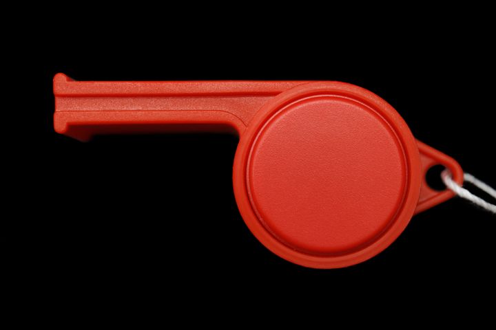 red whistle isolated on black