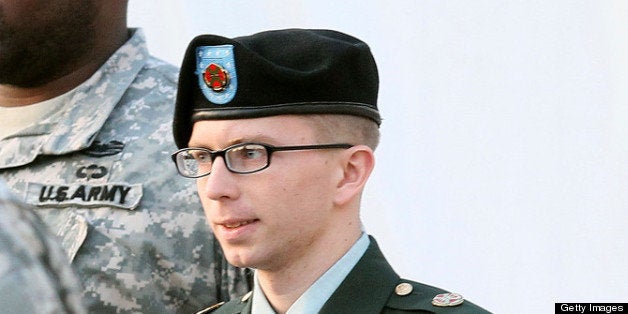 FORT MEADE, MD - FEBRUARY 23: Army Private Bradley Manning is escorted away from his Article 32 hearing February 23, 2012 in Fort Meade, Maryland. During the hearing, Manning deferred his plea to the 22 charges against him and deferred a decision over whether he wanted a military judge or a jury to hear his case. (Photo by Mark Wilson/Getty Images)