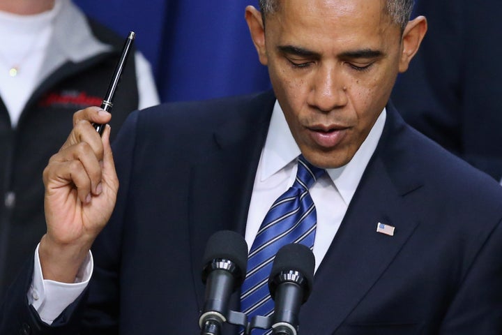 WASHINGTON, DC - NOVEMBER 28: U.S. President Barack Obama holds a pen while saying he is ready to sign legislation taht would extend tax cuts for middle class people during an event in the Eisenhower Executive Office Building November 28, 2012 in Washington, DC. With the end-of-the-year 'fiscal cliff' looming over lawmakers in Washington, Obama will meet with 14 chief executives at the White House later in the day. (Photo by Chip Somodevilla/Getty Images)