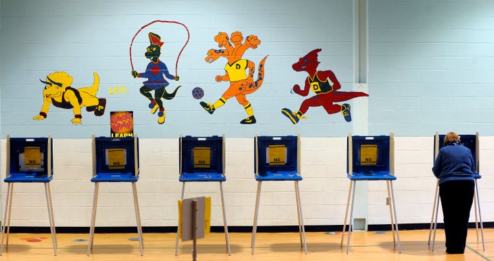 RALEIGH, NC - NOVEMBER 06: A voter casts her ballot in the gymnasium of Douglas Elementary School on November 6, 2012 in