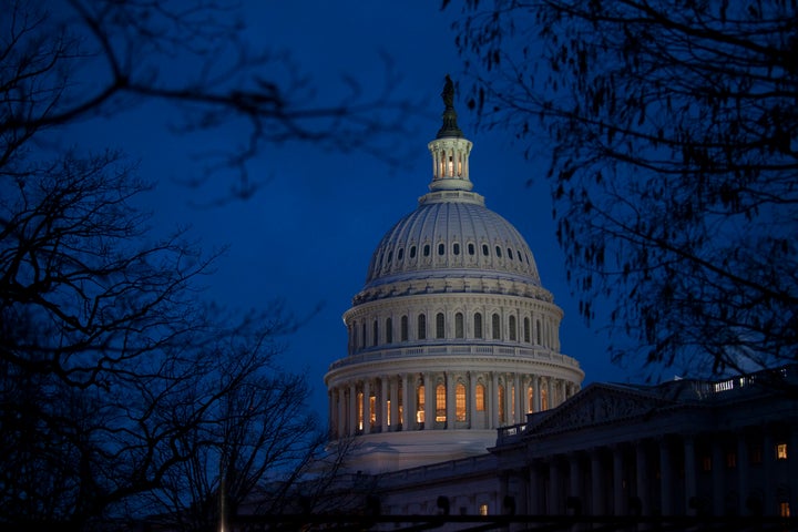 WASHINGTON, DC - DECEMBER 31: The U.S. Capitol illuminates at dusk on Capitol Hill on December 31, 2012 in Washington, DC. Th