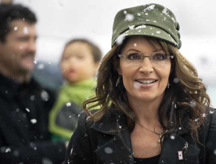 Former Alaska Governor and Republican vice presidential candidate Sarah Palin arrives to sign copies of her recently released book 'Going Rogue: An American Life', sitting in front of a Christmas Tree on December 5, 2009, inside the BJ's discount warehouse in the Fair Lakes shopping mall in Fairfax, Virginia. Well over 1,000 people waited in a rare heavy Washington, DC, snowstorm for an autograph, some overnight. AFP PHOTO/Paul J. Richards (Photo credit should read PAUL J. RICHARDS/AFP/Getty Images)