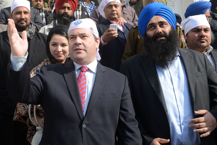 Canada's Minister of Citizenship, Immigration and Multiculturalism, Jason Kenney (L) gestures next to Canada's Minister of State for Democratic Reform and Member of Parliament, Tim Uppal ( R) during a visit to the Sikh Shrine Golden temple in Amritsar on January 11, 2013 . Kenney visited the city to tour the Sikh Shrine and address a press conference where he advised applicants to be cautious of immigration fraud when coming to Canada. AFP PHOTO/ NARINDER NANU (Photo credit should read NARINDER NANU/AFP/Getty Images)