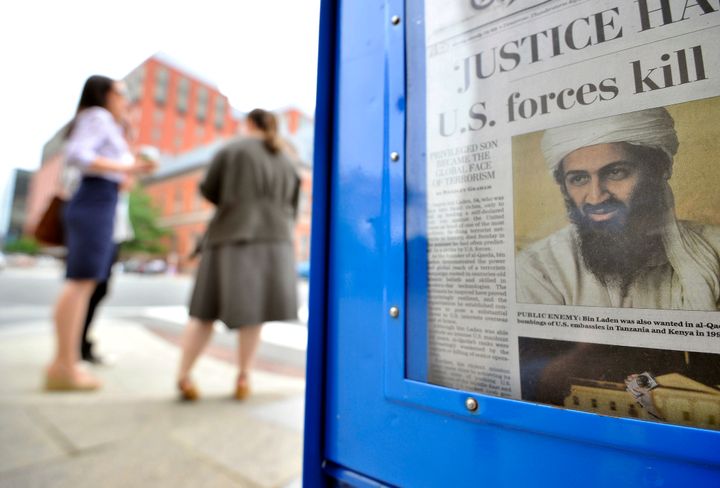 People walk past a newspaper stand in Washington, DC, on May 2, 2011 with a front page news about the killing of al Qaeda leader Osama bin Laden by US forces under the direction of US President Barack Obama. Obama Monday hailed a great day for America after Osama bin Laden's death, but Pakistan faced tough questions over the terror kingpin's roomy hideout in a key garrison city. US officials meanwhile said that DNA testing on Bin Laden's corpse before it was buried at sea with Islamic rituals confirmed the identity of the world's most wanted terrorist, the mastermind of the September 11 attacks in 2001. AFP Photo/Jewel Samad (Photo credit should read JEWEL SAMAD/AFP/Getty Images)