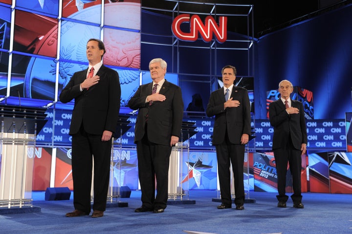 Republican presidential candidates listen to the American national anthem prior to the start of the Florida Republican Presidential debate January 26, 2012 at the University of North Florida in Jacksonville, Florida. From left are: former senator Rick Santorum; former House Speaker Newt Gingrich; former Massachusetts governor Mitt Romney; and Texas Rep. Ron Paul. AFP PHOTO / Stan HONDA (Photo credit should read STAN HONDA/AFP/GettyImages)