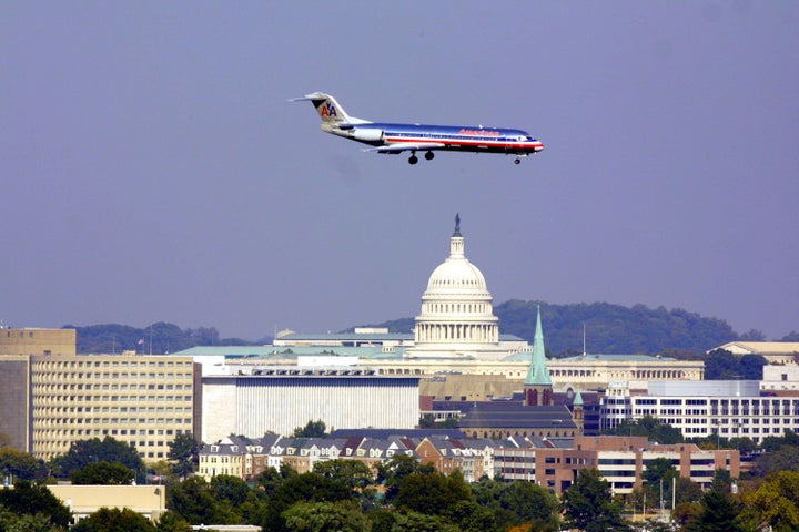 395437 05: With the U.S. Capitol in the background an American airlines shuttle comes in to land at Washington's Reagan National Airport October 5, 2001 in Arlington, Va. With unprecedented security the airport was trying to get back to normal after it reopened yesterday and became the last commercial airport in the U.S. to reopen since the September 11 attacks. (Photo by Joe Raedle/Getty Images)