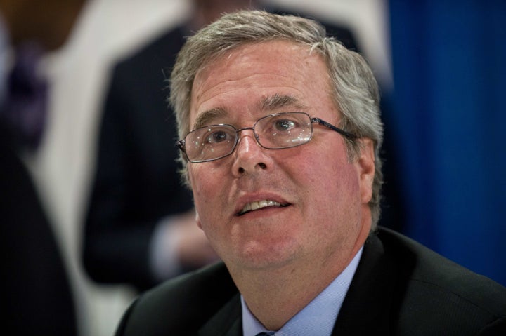 Former Florida governor Jeb Bush speaks with an admirer as he signs the book 'Immigation Wars' he co-authored with Clint Bolick at a book signing during the Conservative Political Action Conference (CPAC) in National Harbor, Maryland, on March 15, 2013. AFP PHOTO/Nicholas KAMM (Photo credit should read NICHOLAS KAMM/AFP/Getty Images)