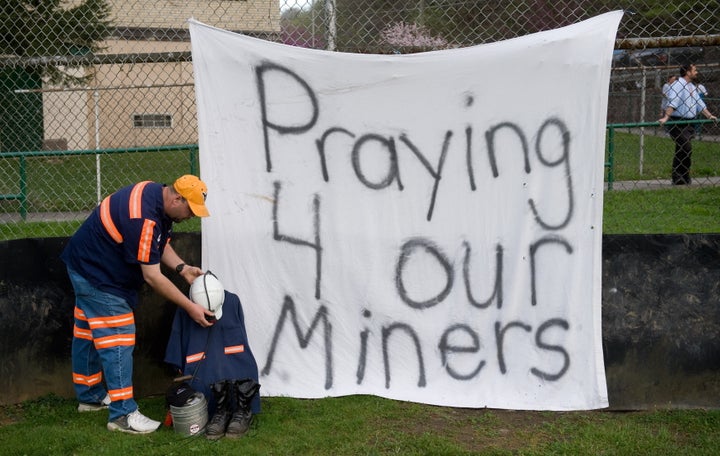 Terry Bailey of Naoma, West Virginia and a coal miner at Progress Coal, sets up a memorial for the 25 miners that were killed in an explosion two days ago at the Upper Big Branch coal mine owned by Massey Energy Company and operated by Performance Coal Company in nearby Montcoal, prior to a candelight vigil in Whitesville, West Virginia, April 7, 2010. AFP PHOTO / Saul LOEB (Photo credit should read SAUL LOEB/AFP/Getty Images)