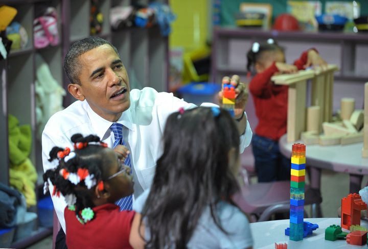 US President Barack Obama helps children place a block while touring a classroom in the Yeadon Regional Head Start Center November 8, 2011 in Yeadon, Pennsylvania. AFP PHOTO/Mandel NGAN (Photo credit should read MANDEL NGAN/AFP/Getty Images)