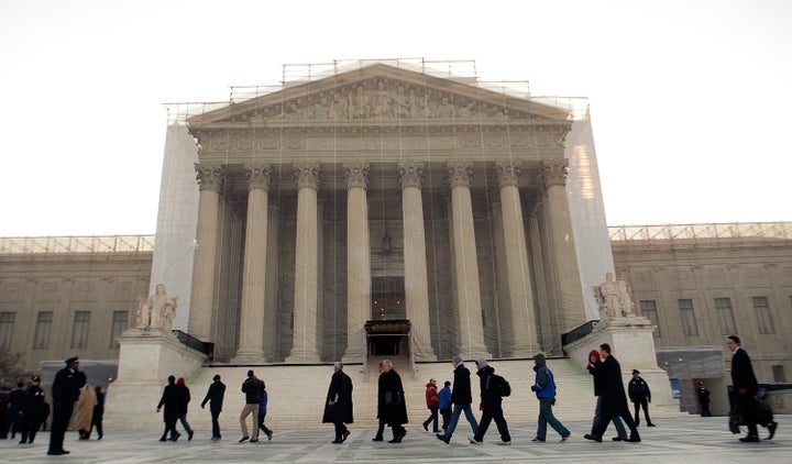 WASHINGTON, DC - MARCH 26: Members of the public enter the Supreme Court March 26, 2013 in Washington, DC. Today the Supreme