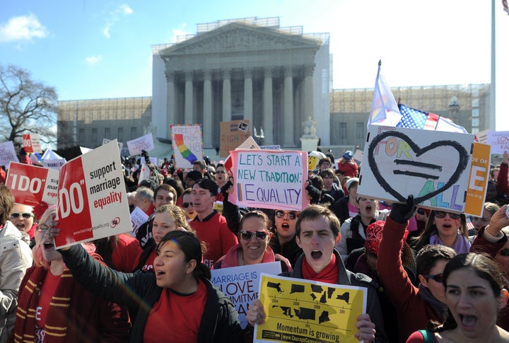 Same-sex marriage supporters shout slogans in front of the US Supreme Court on March 26, 2013 in Washington, DC. The US Supreme Court on Tuesday takes up the emotionally charged issue of gay marriage as it considers arguments that it should make history and extend equal rights to same-sex couples. Waving US and rainbow flags, hundreds of gay marriage supporters braved the cold to rally outside the court along with a smaller group of opponents, some pushing strollers. Some slept outside in hopes of witnessing the historic hearing. AFP PHOTO/Jewel Samad (Photo credit should read JEWEL SAMAD/AFP/Getty Images)