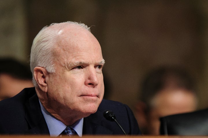 Senator John McCain (R-AZ) listens as former Senator Chuck Hagel (R-NE) testifies before the Senate Armed Services Committee,