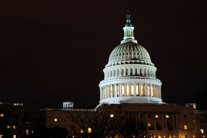 The dome of the U.S. Capitol is lit up in the evening in Washington, D.C., U.S., on Thursday, Feb. 28, 2013. Democrats and Republicans are in a standoff over how avert $85 billion in federal spending cuts set to start before midnight on March 1. Photographer: Pete Marovich/Bloomberg via Getty Images