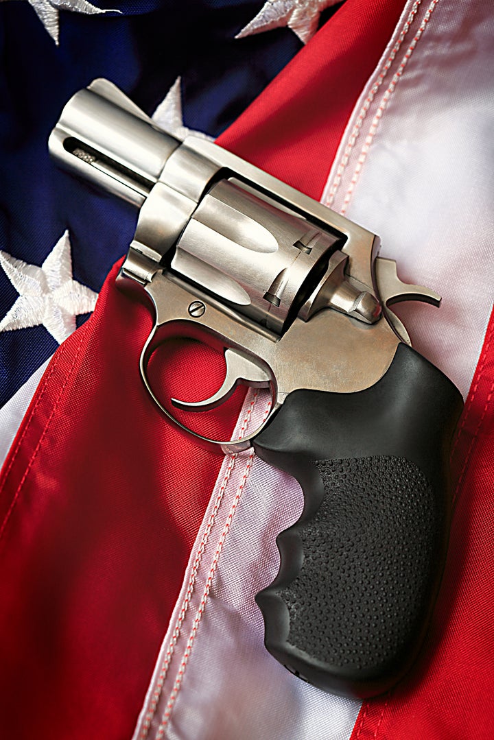 A handgun resting on an American flag, representing the Second Amendment of the US Constitution, the right of patriotic Ameri