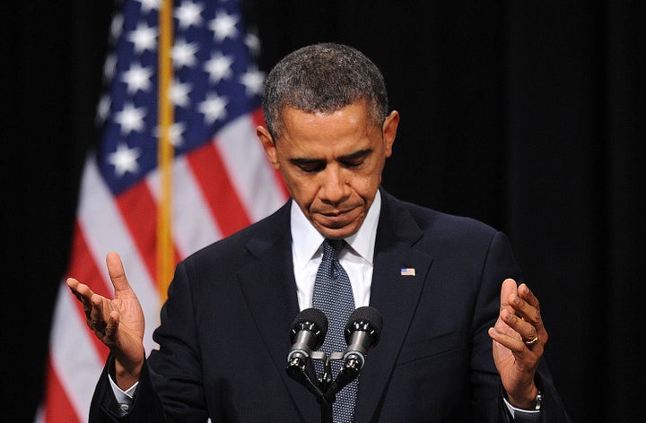 U.S. President Barack Obama prepares to speak during a memorial service for victims of the Sandy Hook Elementary School shooting at Newtown High School in Newtown, Connecticut, U.S., on Sunday, Dec. 16, 2012. Obama said that the nation was 'left with some hard questions' in the aftermath of the massacre at Sandy Hook Elementary school in Newtown, Connecticut, while promising the community to help itself heal. Photographer: Olivier Douliery/Pool via Bloomberg 