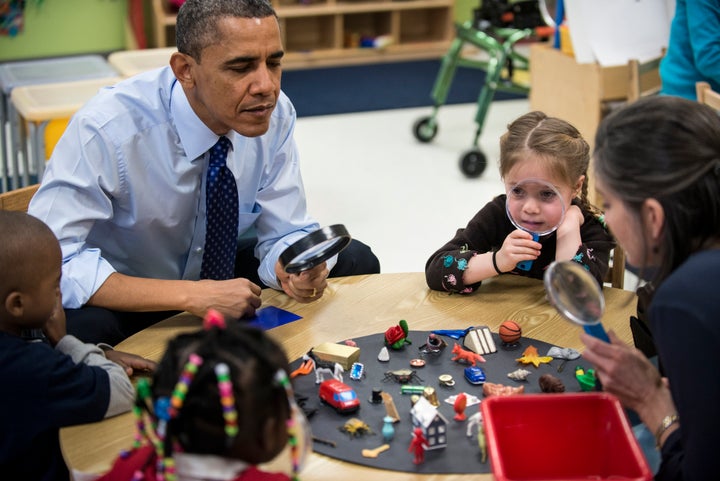 US President Barack Obama plays a learning game while visiting children at College Heights Early Childhood Learning Center February 14, 2013 in Decatur, Georgia. Obama is in Georgia to promote economic and educational initiatives he spoke about in this week's State of the Union. AFP PHOTO/Brendan SMIALOWSKI (Photo credit should read BRENDAN SMIALOWSKI/AFP/Getty Images)